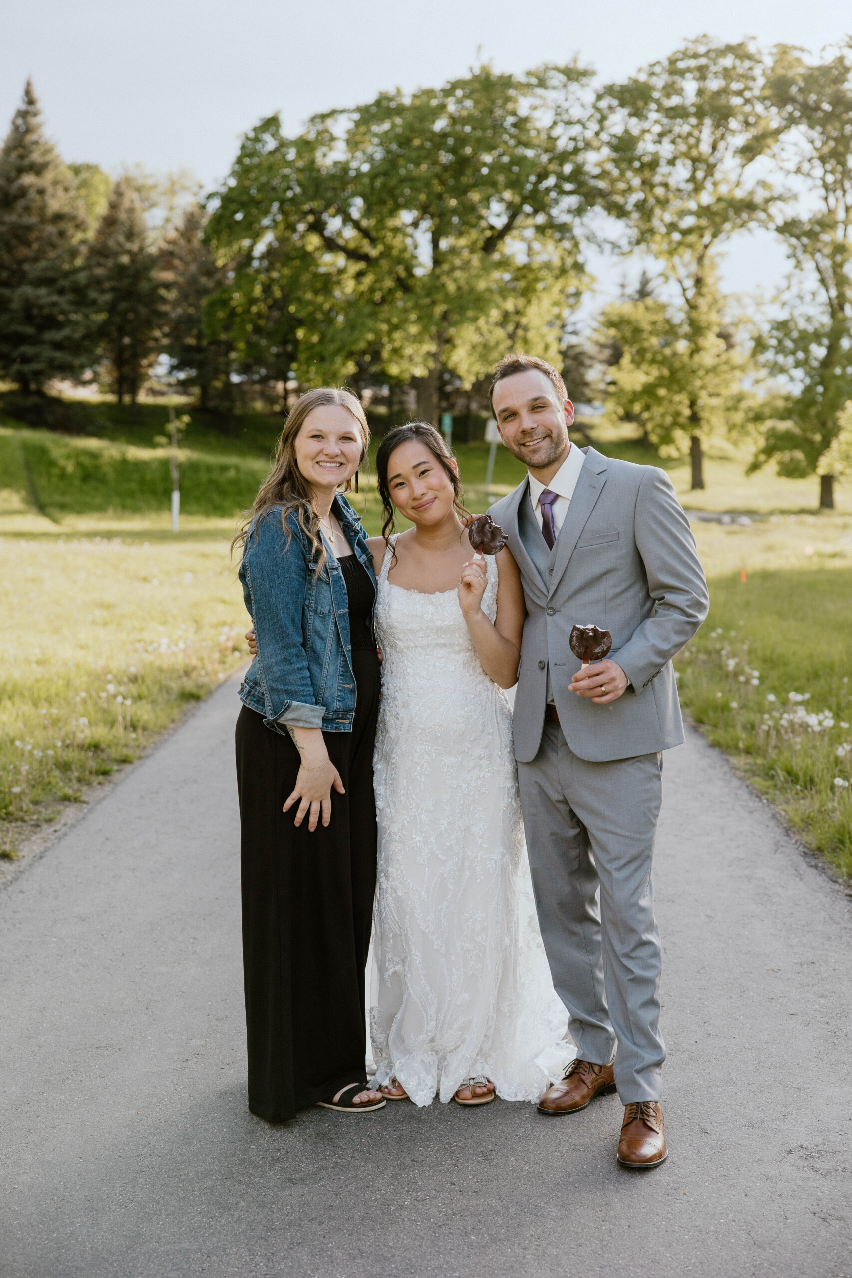 The photographer shares a joyful moment with the newlyweds, capturing memories that will last a lifetime.